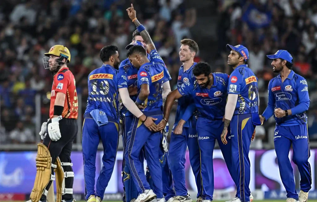 TOPSHOT - MI captain Hardik Pandya (3L) celebrates with teammates after taking the wicket of Punjab Kings' Josh Inglis (L) during the Indian Premier League (IPL) Twenty20 second Qualifier cricket match between Punjab Kings and Mumbai Indians at the Narendra Modi Stadium in Ahmedabad on June 2, 2025. MI vs PBKS